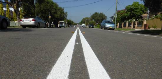 What does it mean when an area of road is painted with white diagonal  stripes and surrounded by a broken white line? - Theory Test