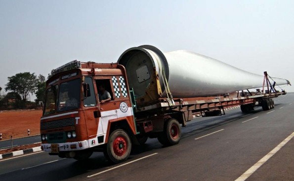 Flat-bed truck carrying a wind turbine. This is a long load